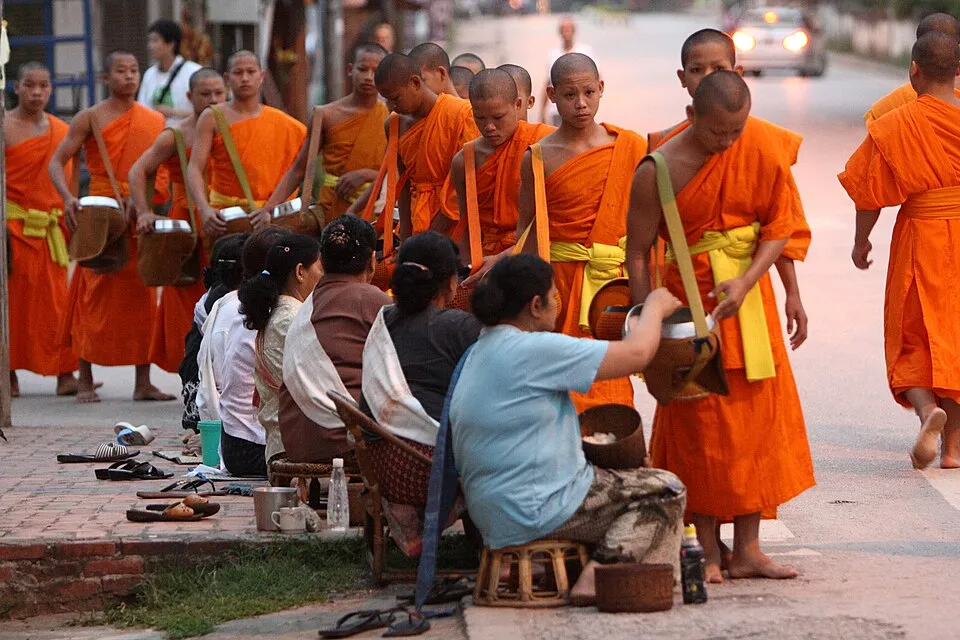 Alms giving at dawn